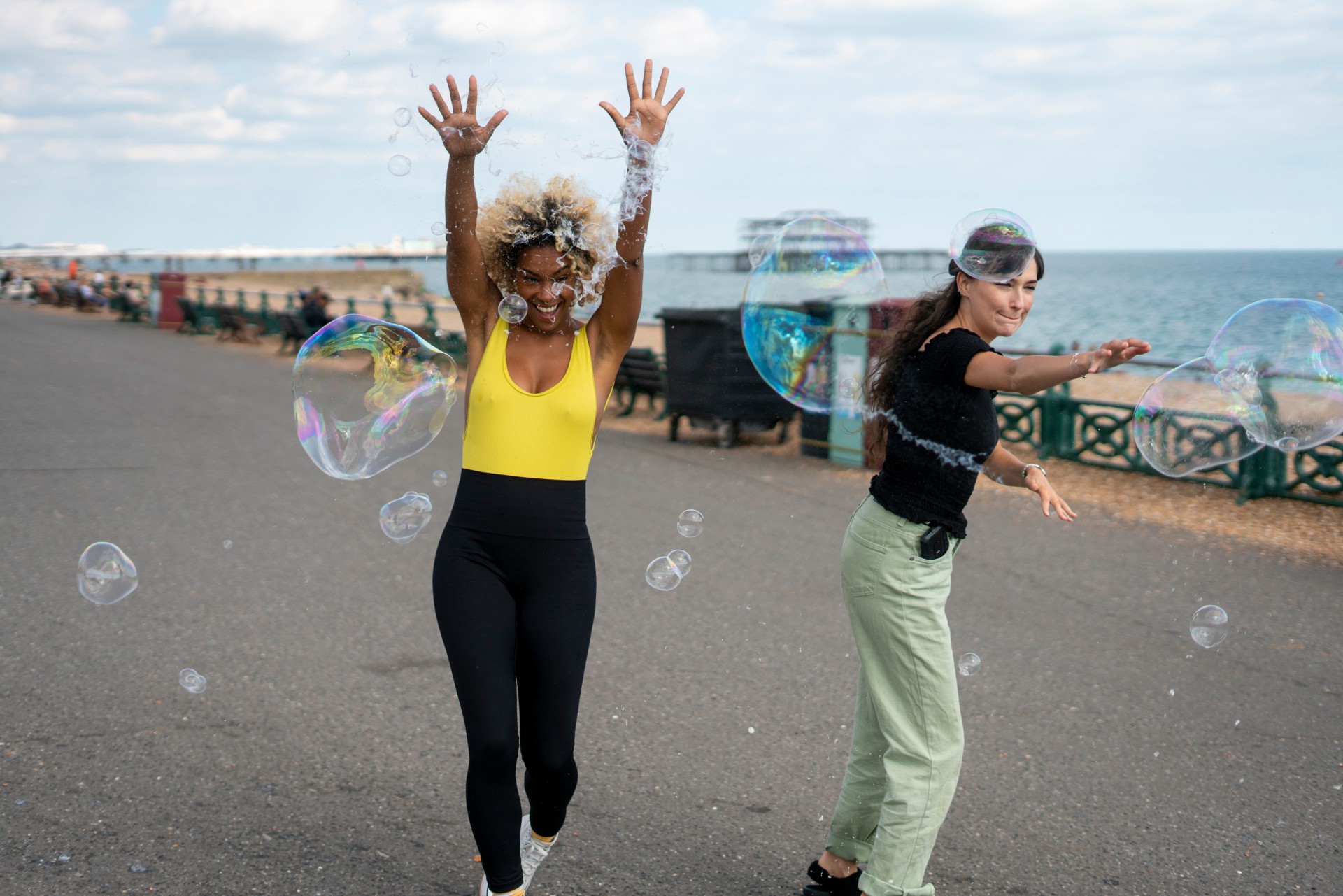 Study in Brighton - two girls surrounded by bubbles on Brighton seafront